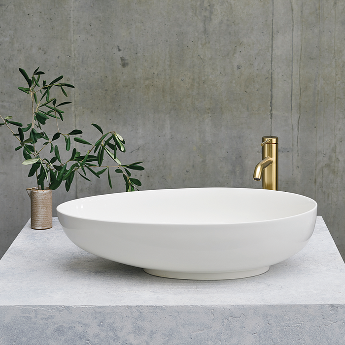 Luxury Bathroom Ideas | For an unmissable statement in your stone bathroom, consider a luxury bath and matching basin